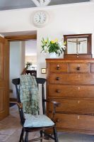 Chest of drawers and chair in living room 