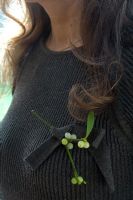 Woman wearing mistletoe corsage