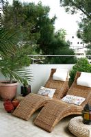 Sun loungers on modern terrace 