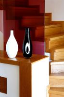 Vases on sideboard at bottom of staircase 