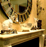 Decorative mirror above mantelpiece