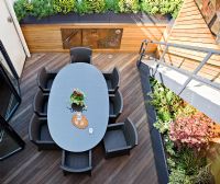 Modern roof terrace with dining table 
