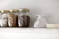 Storage jars on white shelf