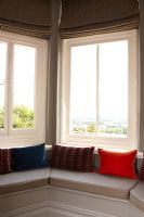 Window seat with colourful cushions 