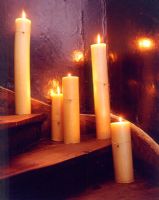 Lit church candles on staircase detail 