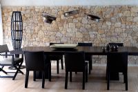 Modern dining room with stone wall 