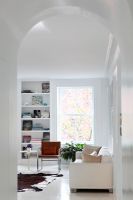 Modern white living room with arched doorway