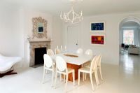 Modern white dining room with fireplace
