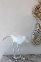 Modern white bird sculpture on mantelpiece