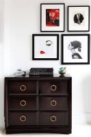 Chest of drawers and pictures in bedroom 