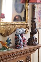 Decorative china cats on mantelpiece, detail