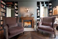 Armchairs and fireplace in modern living room 