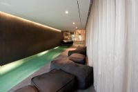 Soft seating around indoor swimming pool 
