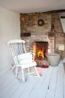 White rocking chair by fireplace