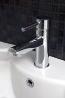 Modern chrome tap on bathroom sink, detail