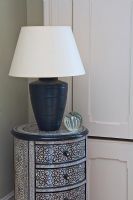 Decorative chest of drawers and lamp, detail