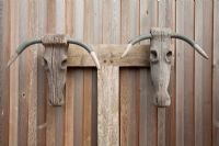 Wooden sculpture on fence