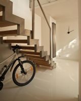 Bicycle under modern staircase 