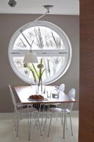 Modern dining room with round window