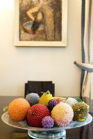 Bowl of colourful balls on dining table