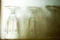 Detail of glassware behind frosted glass
