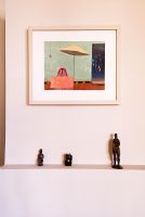 Modern painting and figures on mantelpiece 
