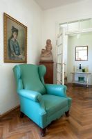 Green leather armchair in classic living room