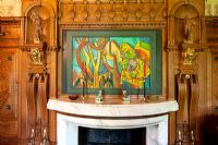Modern artwork above classic fireplace 