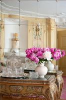 Flowers and glassware on ornate console table