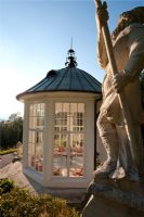 Summerhouse and statue in country garden