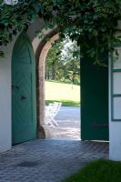 Huge green wooden doors to courtyard 