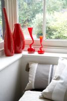 Red glassware on living room windowsill 