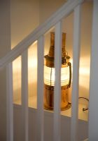 Brass lantern on modern staircase 
