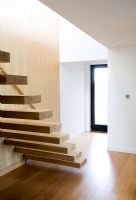 Modern hallway and wooden staircase 