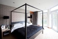 Four poster bed in modern bedroom 