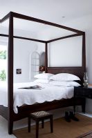 Four poster bed in classic bedroom 