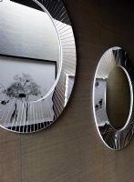 Round mirrors and artwork in modern corridor
