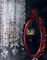 Bead curtain and ornate red mirror, detail