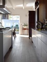 Modern kitchen with stripped wooden floor