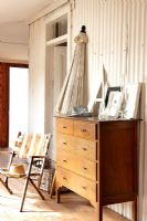 Deck chair and wooden chest of drawers