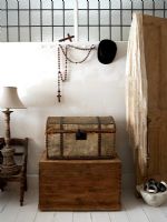 Vintage wooden trunks in modern bedroom