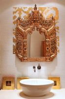 Modern bathroom sink and ornate mirror 