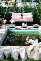 Modern swing seat by exterior pond