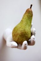 wall mounted hand holding a pear, detail