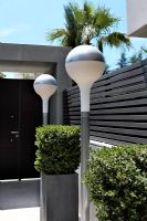 Modern exterior lamps leading to front gate