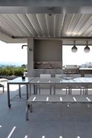 Table and chairs on modern roof terrace 