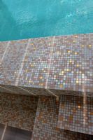 Modern swimming pool with mosaic tile steps