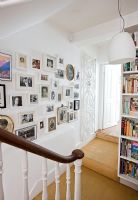 Display of framed photographs in hallway