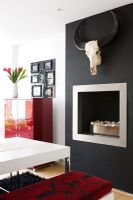 Contemporary dining room with fireplace and wall mounted animal skull