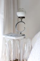 Contemporary lamp on white bedside cabinet